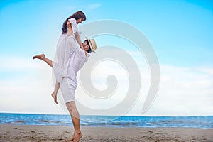 Happy Romantic Couples lover holding hands together walking on the beach