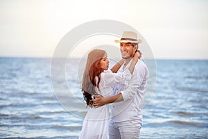 Happy Romantic Couples lover holding hands together walking on the beach