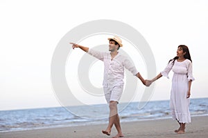 Happy Romantic Couples lover holding hands together walking on t
