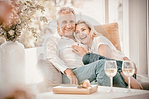 Happy romantic mature couple sitting on armchair