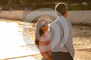 Happy Romantic Mature Couple Walking Together Along The Beach In Sunset