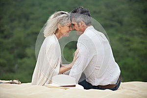 happy romantic middle aged couple enjoying beach