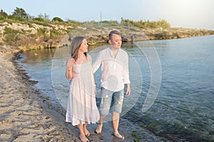 Happy Romantic Middle Aged Couple Enjoying Beautiful Sunset Walk on the Beach.