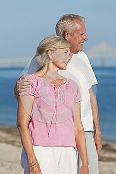 Happy Romantic Senior Couple Embracing on Beach photo