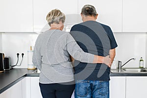 Happy romantic senior couple in love cooking at home