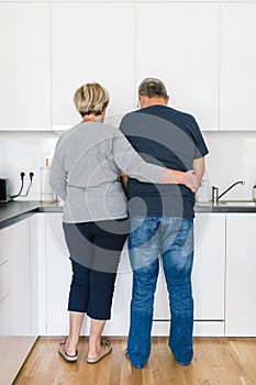 Happy romantic senior couple in love cooking at home