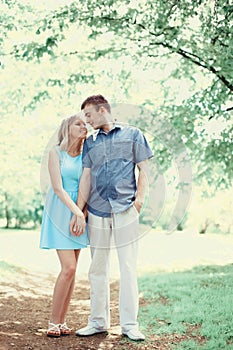 Happy romantic young couple in love walking together in spring