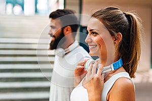 Happy runner couple exercising outside as part of healthy lifestyle. People sport running concept