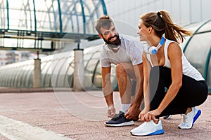 Happy runner couple exercising outside as part of healthy lifestyle. People sport running concept