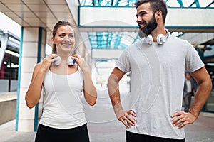 Happy runner couple exercising outside as part of healthy lifestyle. People sport running concept