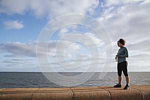 Happy runner woman drinking water