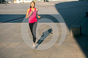 Happy running woman in the street stock photo