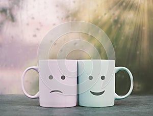 Happy and sad face, cup couple on a window ledge cuddle each other, hot drink on a rainy day, love, relationship and friendship