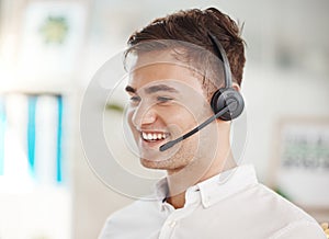 Happy sales man, call center agent, and contact us telemarketing worker customer service help desk in office. Smile