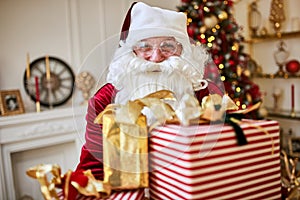 Happy Santa Claus brought many gifts to children.  New year and Merry Christmas holidays concept