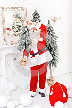 Happy Santa Claus carrying gifts to children