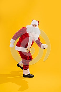 Happy Santa Claus dancing twist dance, rock-n-roll fashion