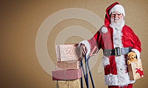 A happy Santa Claus delivering presents with trolley in a postal theme with a plain background and copy space