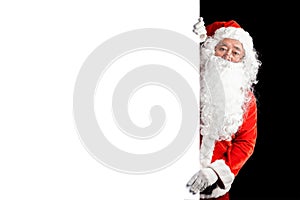 Happy Santa Claus holding blank advertisement banner background with copy space. Smiling Santa Claus pointing in white blank sign