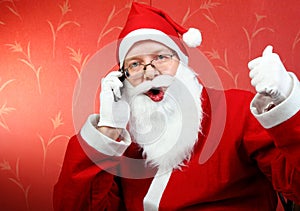Happy santa claus with phone