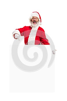 Happy Santa Claus pointing on blank advertisement banner background with copy space. Smiling Santa Claus pointing in