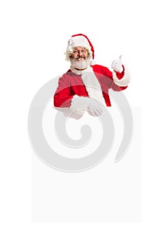 Happy Santa Claus pointing on blank advertisement banner background with copy space. Smiling Santa Claus pointing in