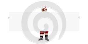 Happy Santa Claus pointing on blank advertisement banner background with copy space. Smiling Santa Claus pointing in