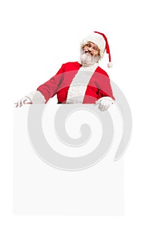 Happy Santa Claus pointing on blank advertisement banner background with copy space. Smiling Santa Claus pointing in