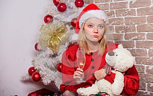 happy santa girl drink champagne toy bear. xmas party mood. celebrate new year together. merry christmas to you. family