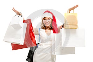 Happy santa woman with bags. Christmas shopping.
