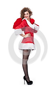 Happy Santa young woman holding full big red bag of gifts, isolated on white background.