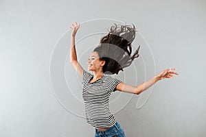 Happy satisfied asian woman with flying hair