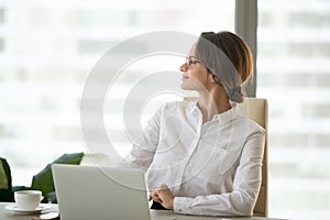 Happy satisfied businesswoman enjoying business success thinking