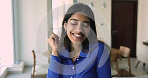 Happy satisfied Indian new homeowner girl posing for portrait