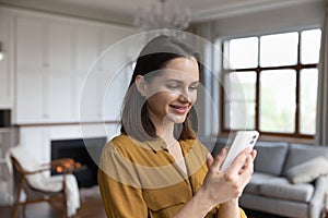 Happy satisfied millennial cellphone user woman browsing internet