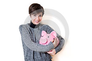 Happy about savings on a piggy bank