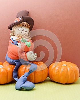 Happy Scarecrow Hugging A Pumpkin