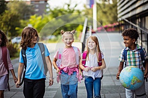 Happy school children. Group of elementary age schoolchildren outside