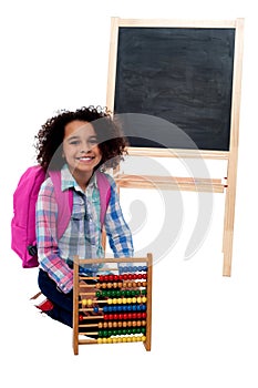 Happy school girl with abacus and pink backpack