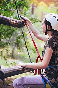 Happy school girl enjoying activity in a climbing adventure park