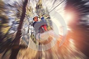 Happy school girl enjoying activity in a climbing adventure park