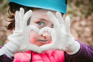 Happy school girl enjoying activity in mountain climbing adventure Park on a spring day