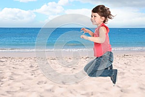 School girl jumping on beach near sea, space for text. Summer holidays