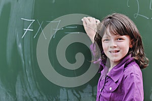 Happy school girl on math classes