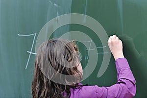 Happy school girl on math classes