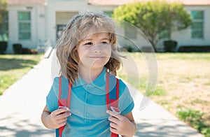 Happy school kid is going to school for the first time. Child boy with bag go to elementary school. Child of primary