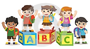 Happy school kids with alphabet blocks.