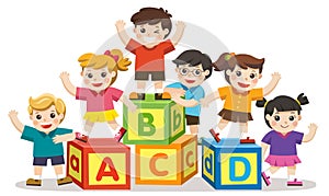 Happy school kids with alphabet blocks.