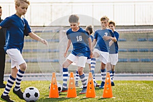 Happy School Kids Practice Soccer With Young Coach