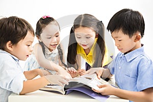 Happy school kids studying together photo